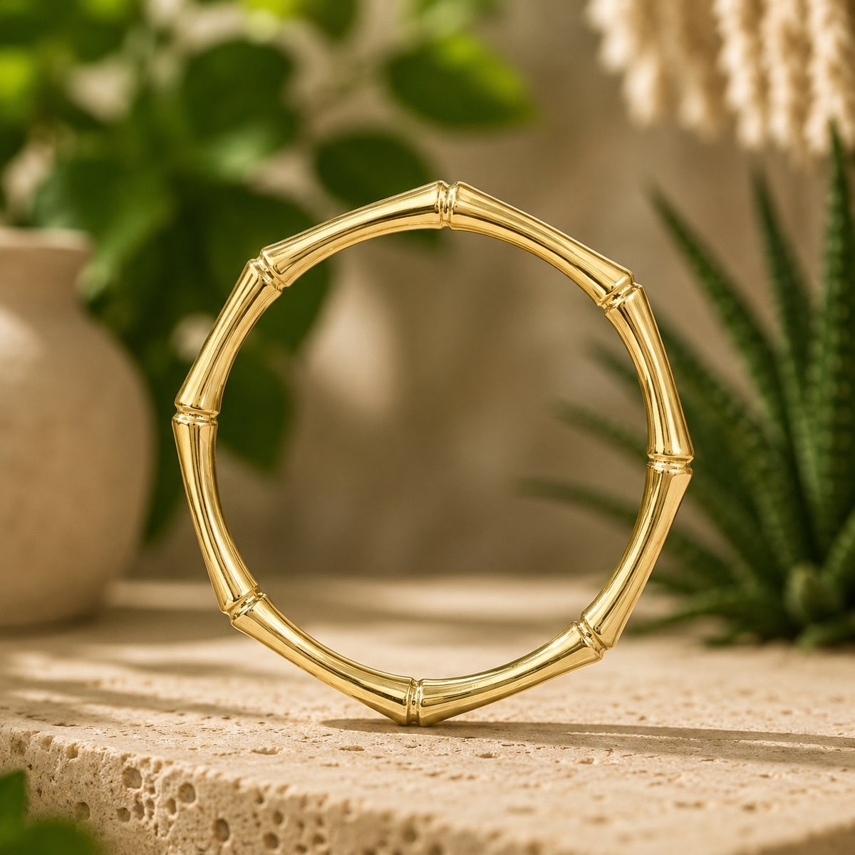 brass bamboo style bracelet on a wooden surface with a natural background