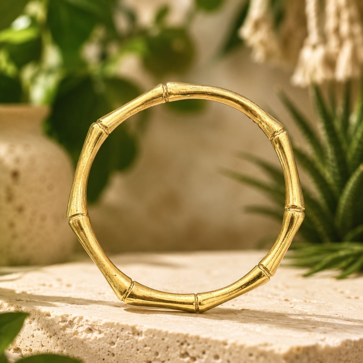 brass bamboo style  bracelet on a wooden surface with a natural background