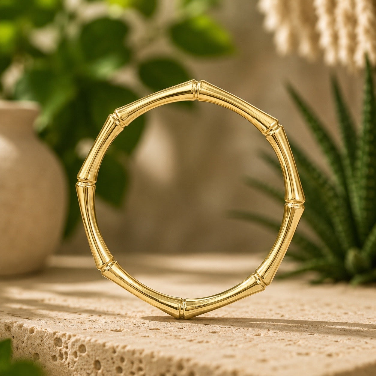 brass bamboo style  bracelet on a wooden surface with a natural background