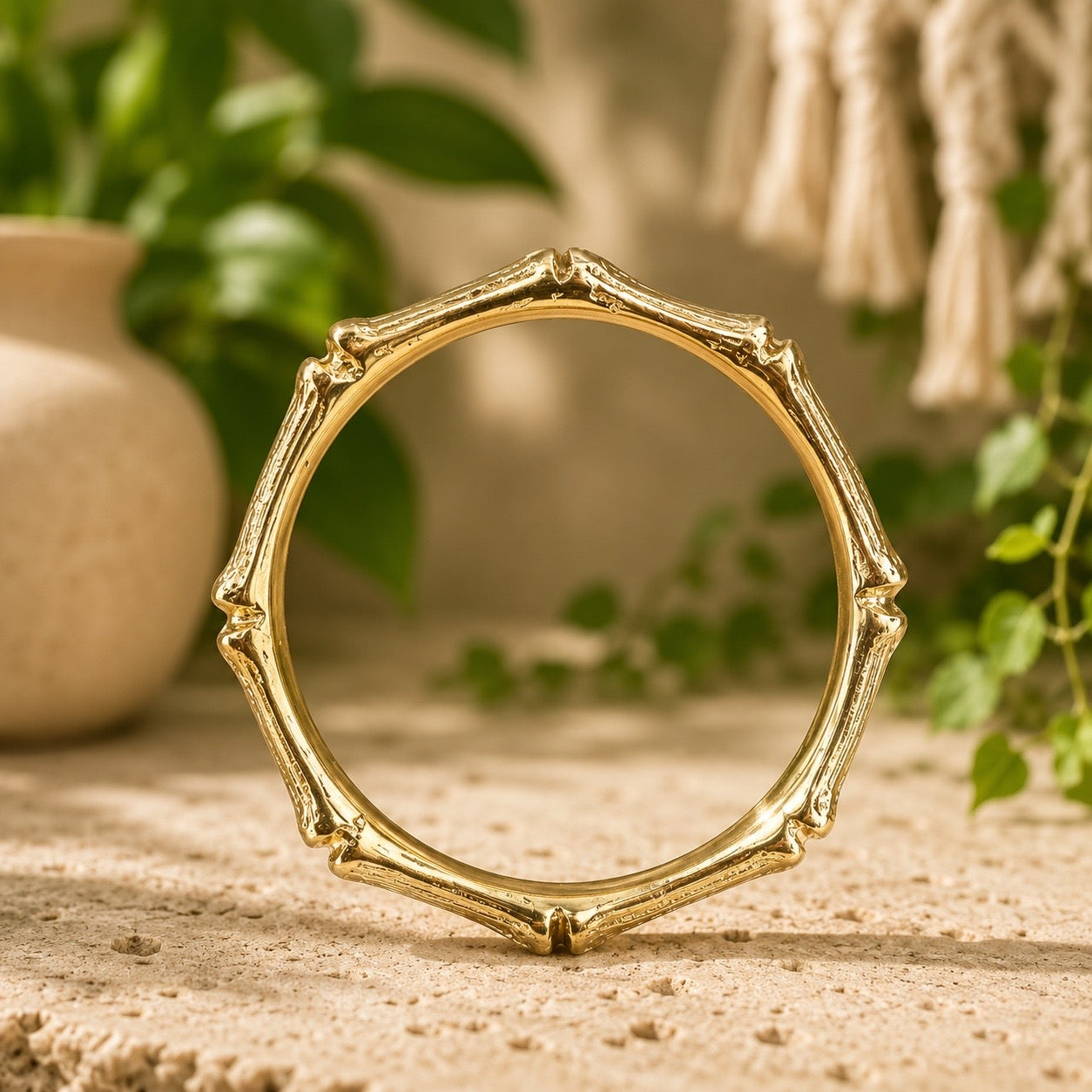 brass bamboo style  bracelet on a wooden surface with a natural background